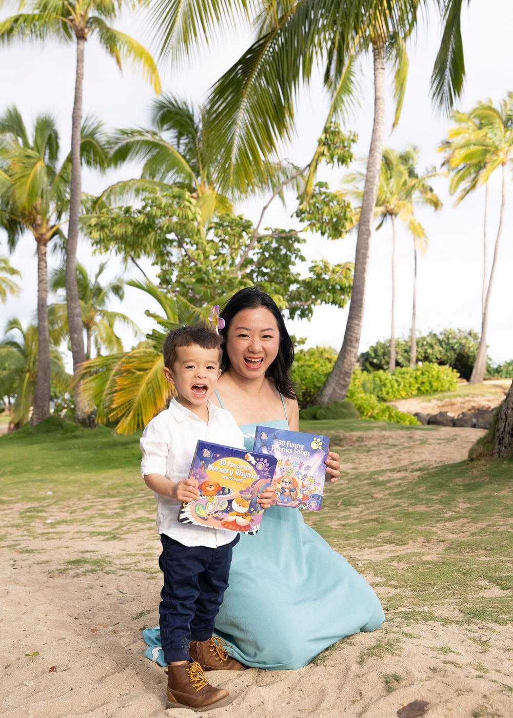 A parent and child holding Go Go Fun Learning English sound books outdoors