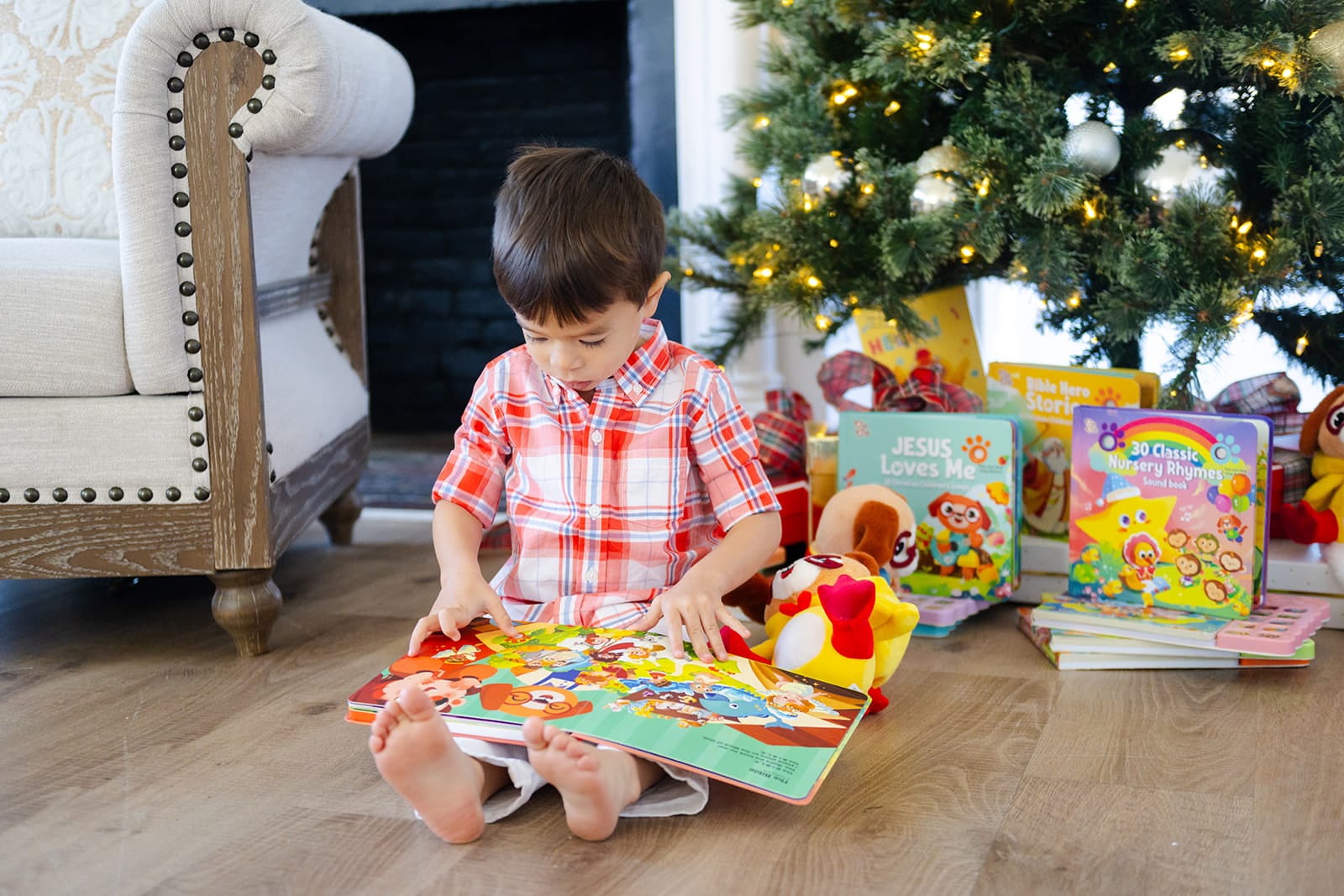 Toddler sitting and reading a Go Go Fun Learning sound book